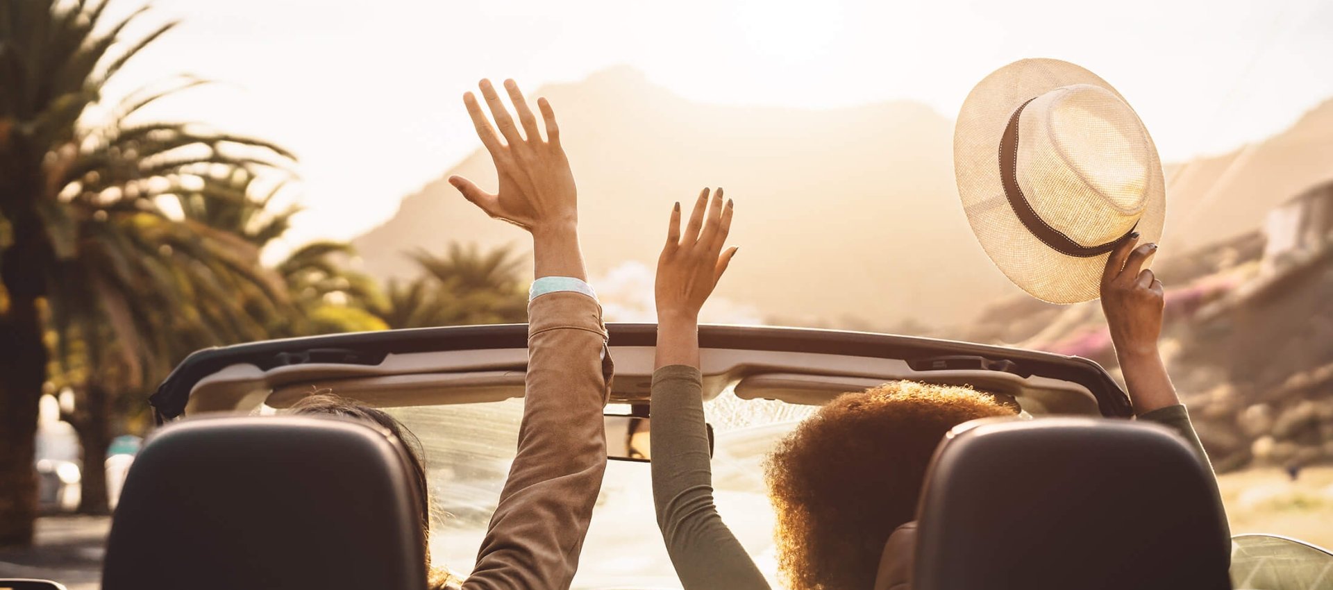 People driving a convertible in Hawaii