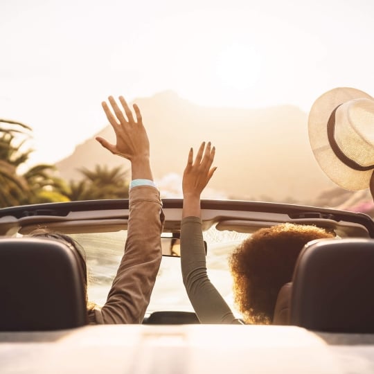 People driving a convertible in Hawaii