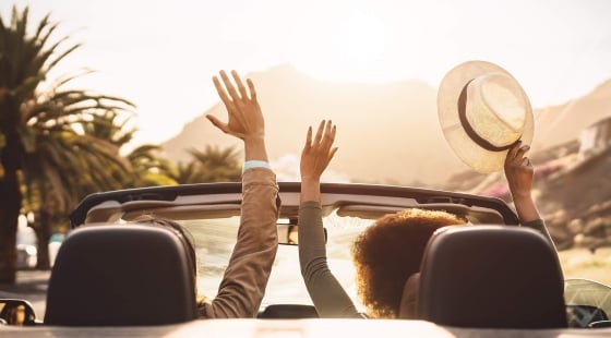 People driving a convertible in Hawaii