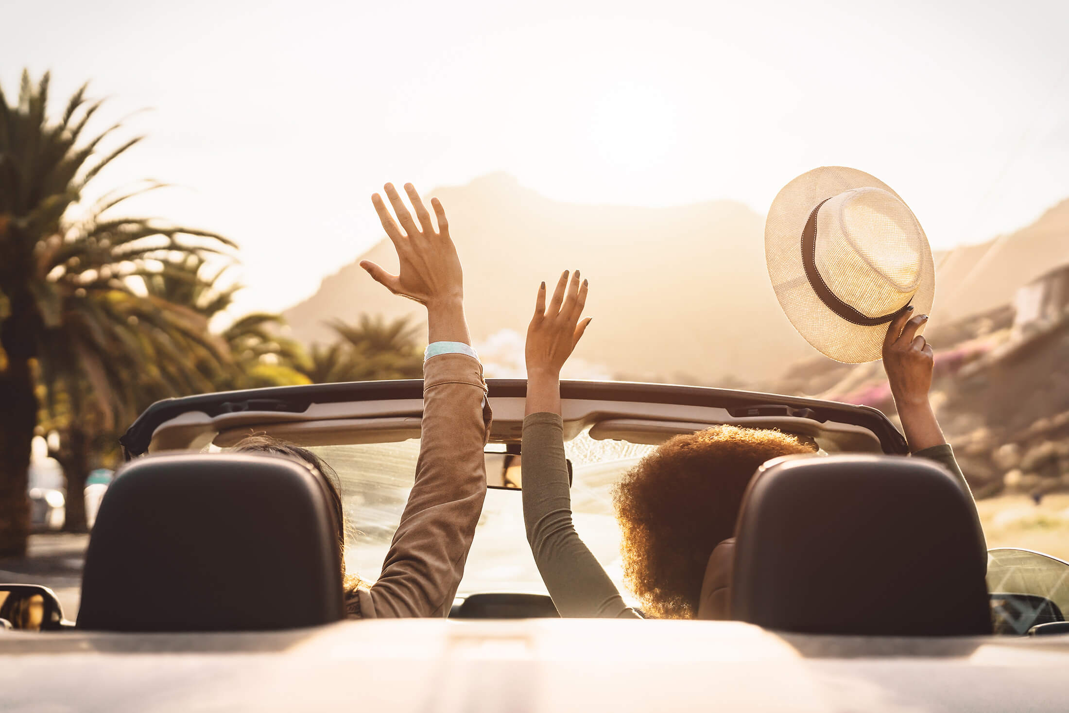 People driving a convertible in Hawaii