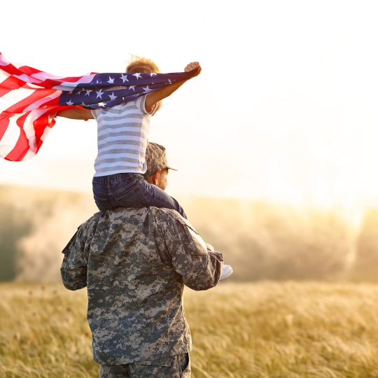 Soldier with child holding flag