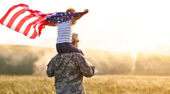 Soldier with child holding flag