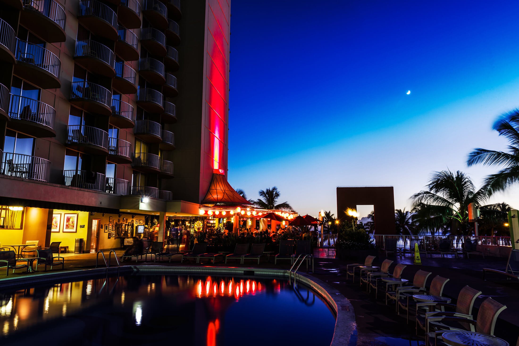 Tiki’s Grill & Bar; Twin Fils Tiko's Groll Bar by Honolulu beach during Hawaiian Sunset