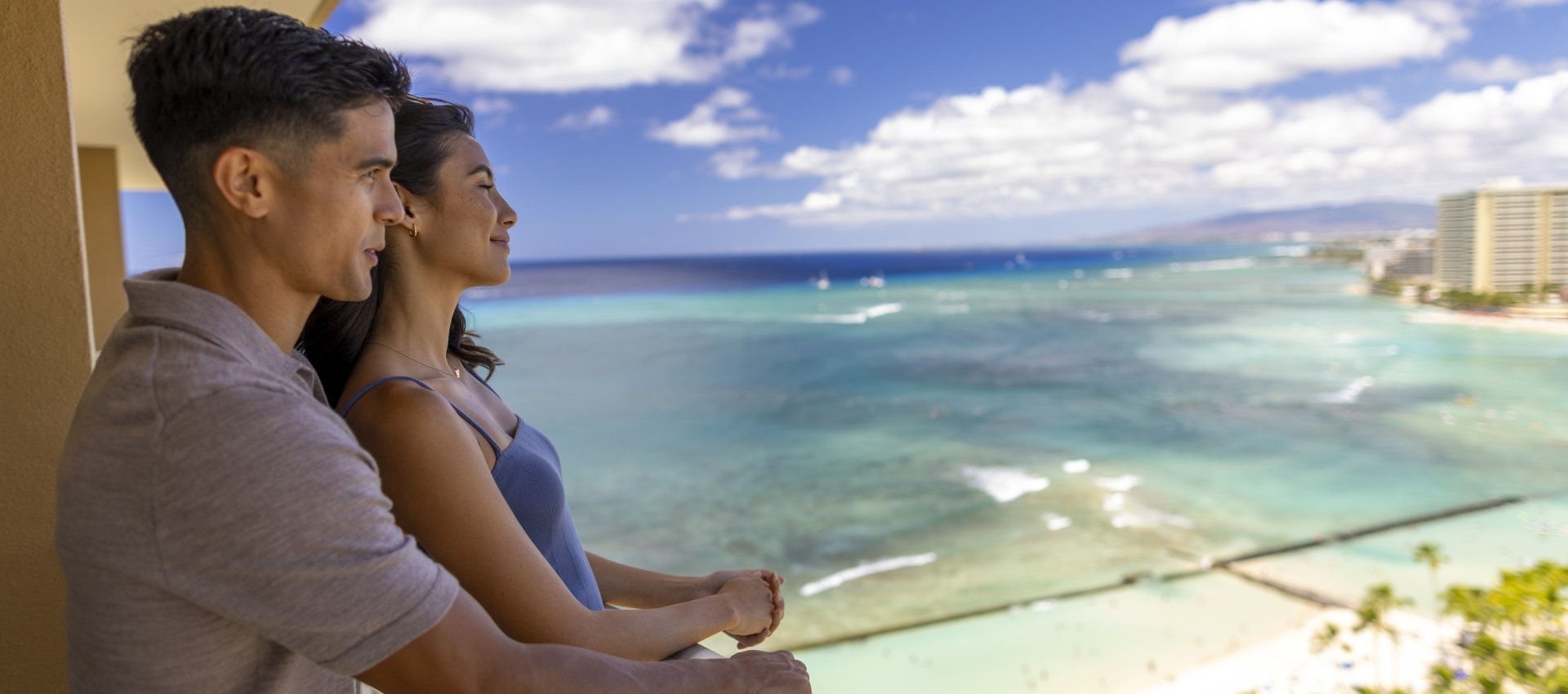 Couple looking off balcony at Waikiki beach