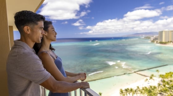 Couple looking off balcony at Waikiki beach