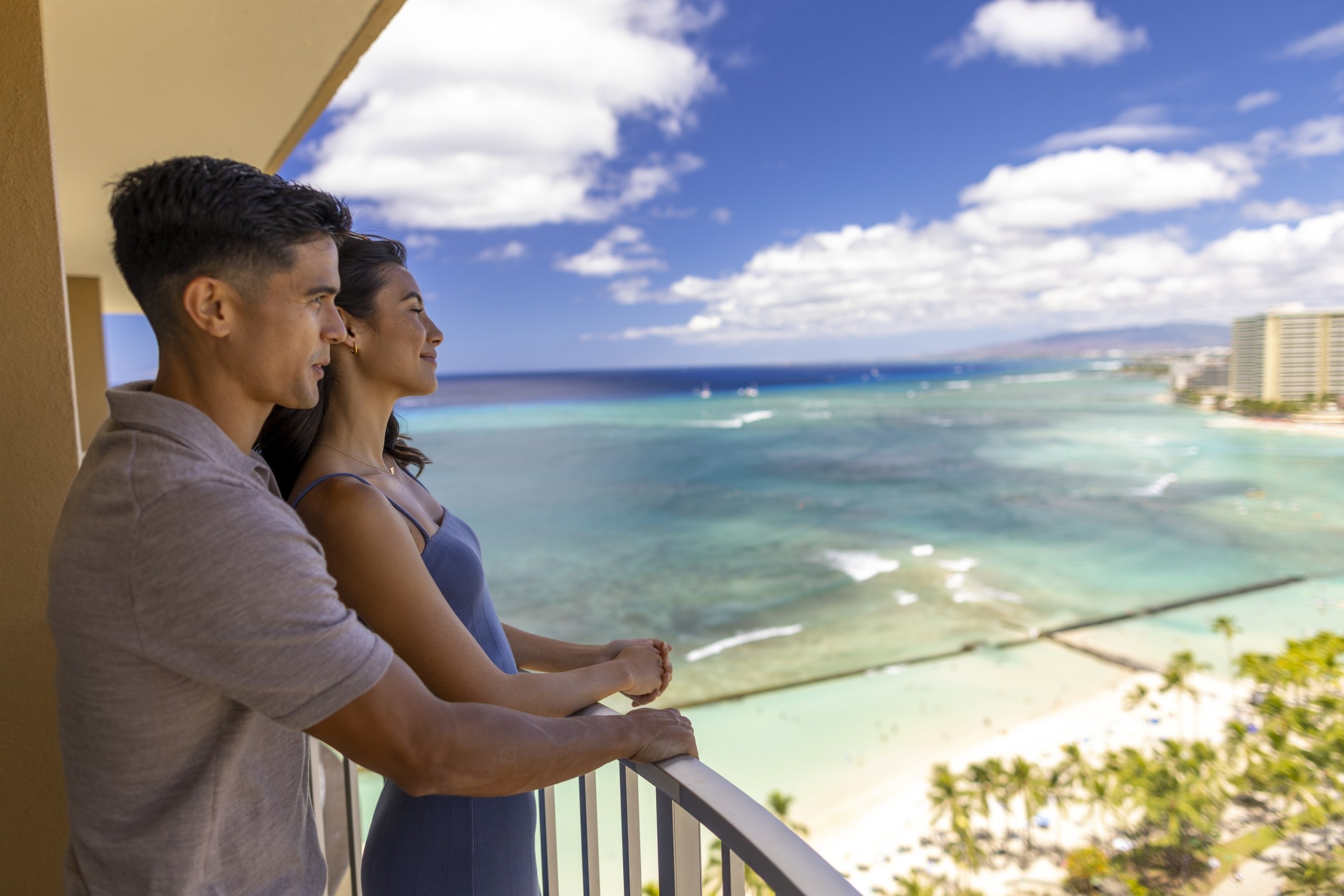 Couple looking off balcony at Waikiki beach