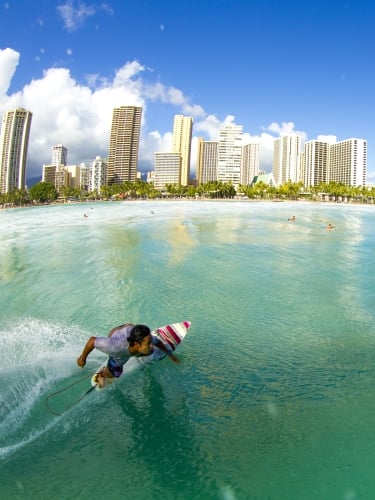 Surfer with city in the background