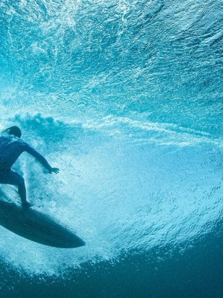 Surfer riding a wave in Waikiki