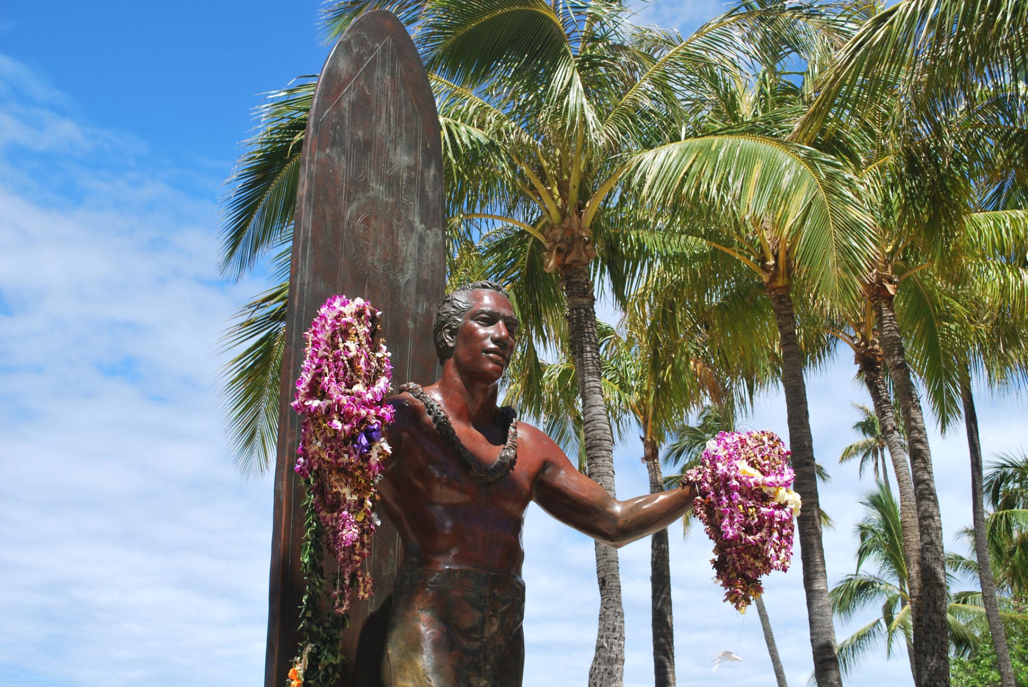 Statue of a surfer Duke Kahanamoku welcomes you to Waikiki with open arms.