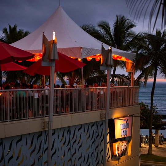 Tiki's Grill & Bar exterior shot of patio at sundown.