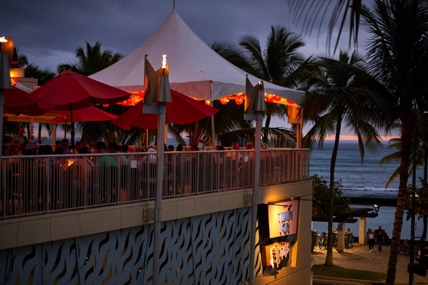Tiki's Grill & Bar exterior shot of patio at sundown.