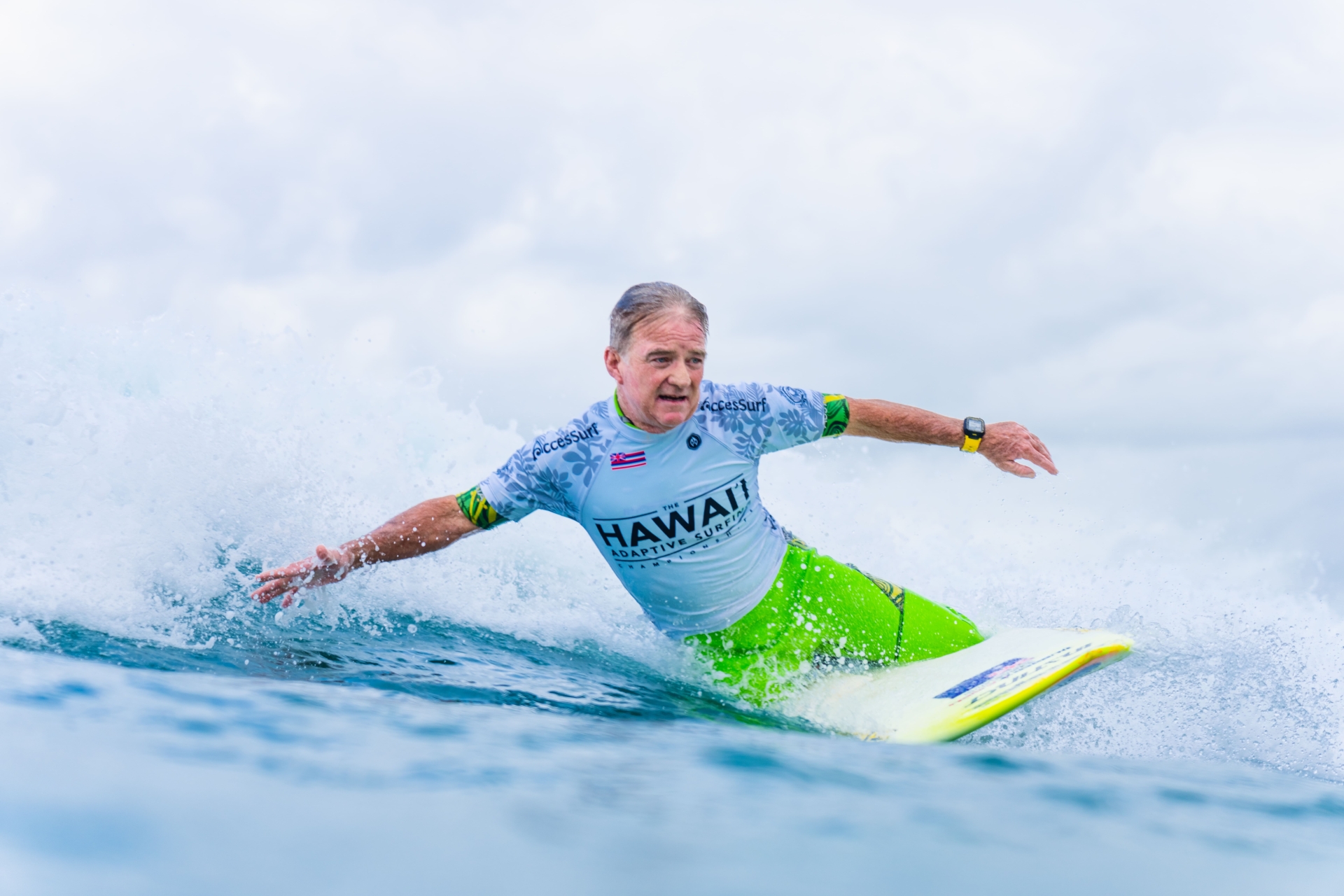 Man on surfboard doing accessible water sports in the ocean.