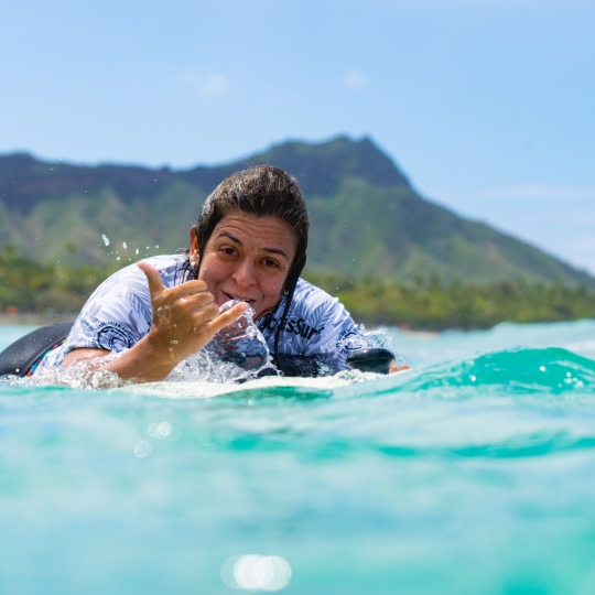 hang loose sign from an individual while doing accessible water sports