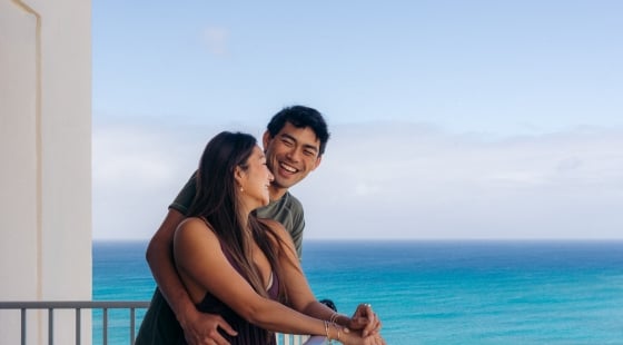 Couple on balcony with ocean view