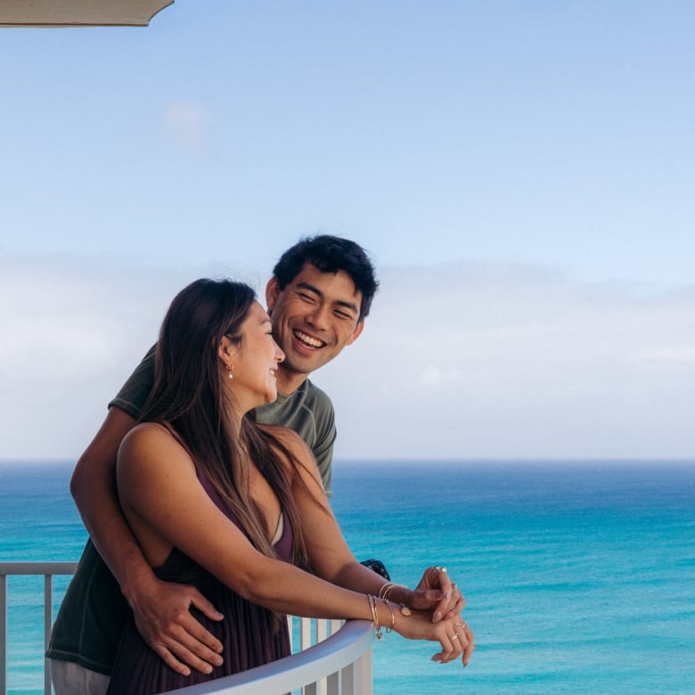 Couple on balcony with ocean view