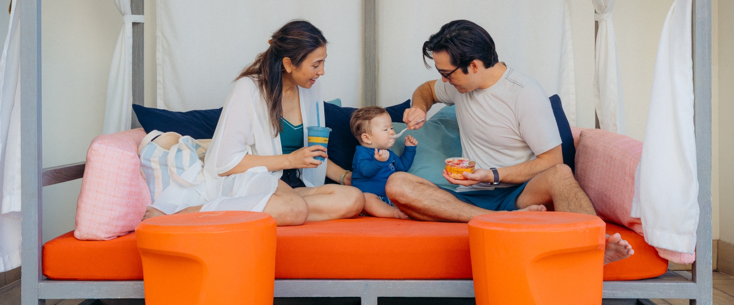 Family with dad feeding baby